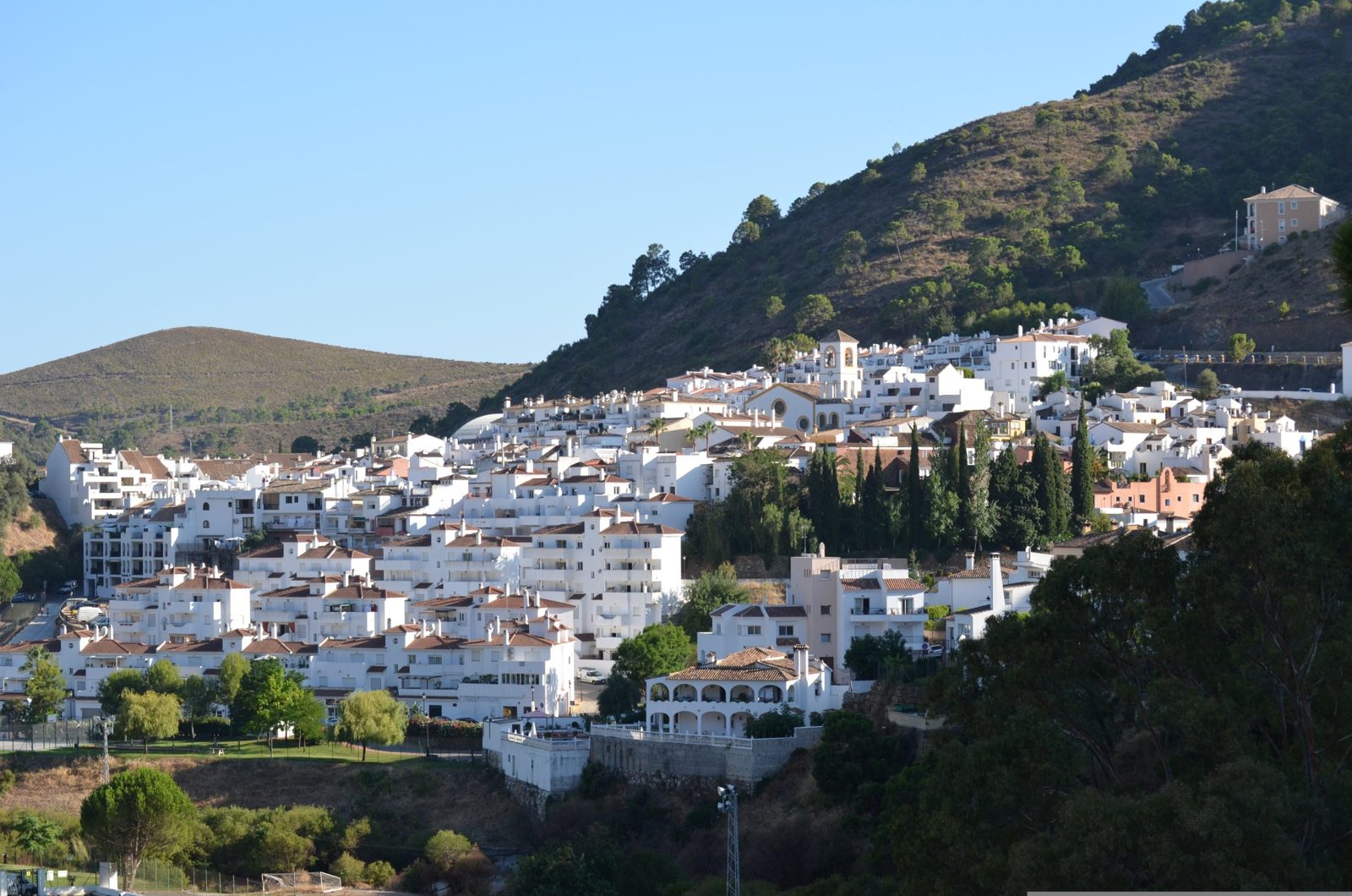 White village of Benahavís on a wooded hillside